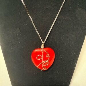 Silver-wrapped red stone heart pendant necklace.